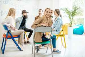 woman smiles during group therapy program