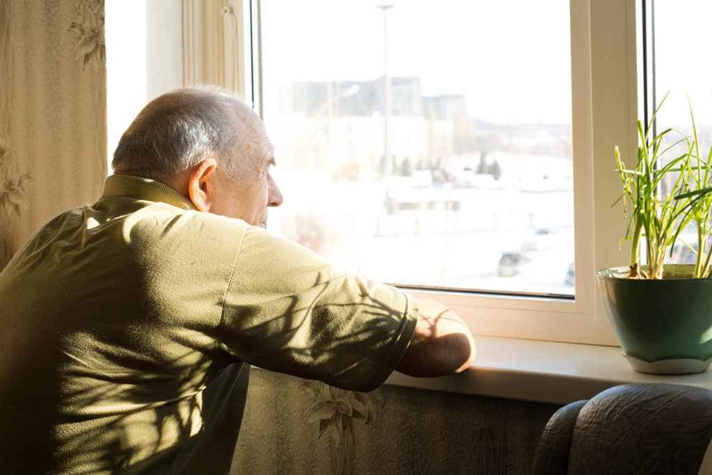 an older man thinking about risk factors for addiction for his grandkids