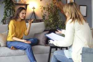 a woman talking to her therapist during a dialectical behavioral therapy program