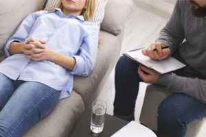 a woman talking to her doctor during therapy at a meth addiction treatment center