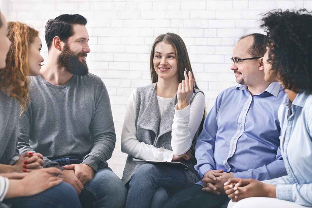 group of people talking about the benefits of an alumni program