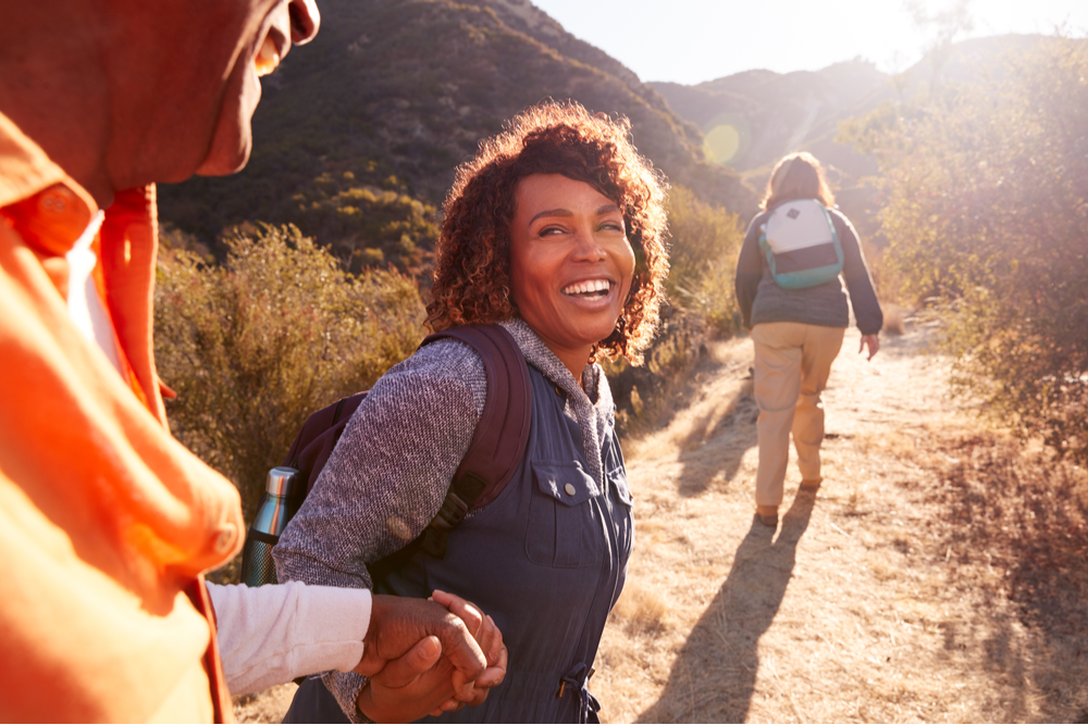 Woman hiking with group for addiction treatment and the great outdoors