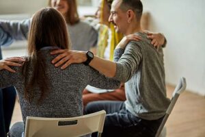 a group talks in a drug and alcohol detox center