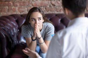 a person talks to a therapist in an outpatient rehab center