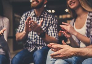 a group celebrates in an alcohol addiction treatment center