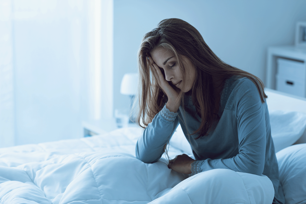 a woman struggles to get out of bed due to the unpleasant symptoms of heroin withdrawal