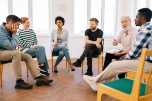 a group in a drug rehab program meets in a circle