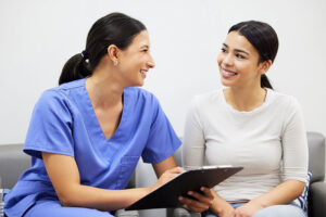 a nurse talks with a client at an outpatient rehab program