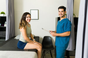 a medical worker and a patient in an exam room completing admissions for a residential treatment program