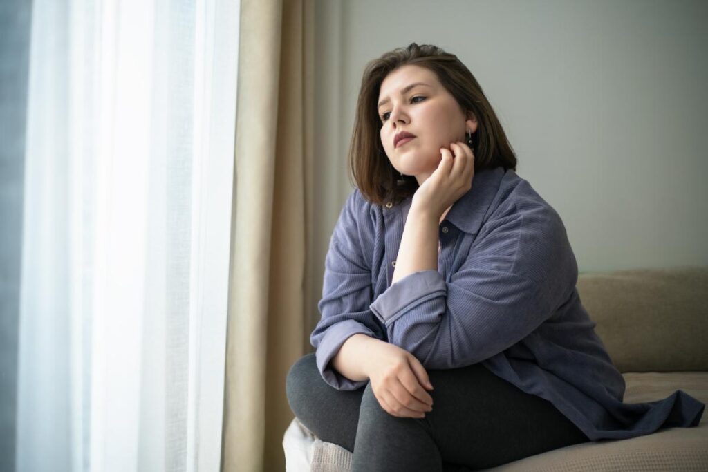 person pensively looking out window thinking about xanax abuse