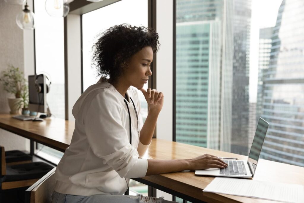 person on laptop at home logging into an online counseling session