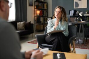 A therapist works with a patient in an inpatient addiction treatment program.